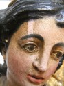 Immaculate Conception of Mary. Wooden polychrome sculpture. XVIII century. Poland. Close-up of the face during surface chemical cleaning test.
